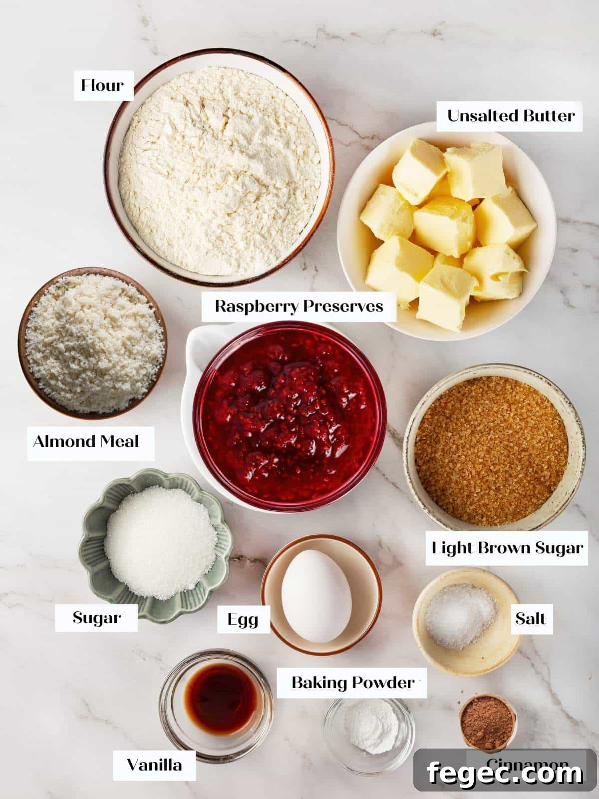 Measured Linzer cookie ingredients displayed in bowls on a counter before mixing begins.