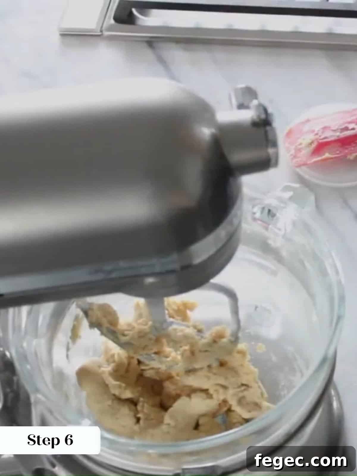 Flour mixture added to linzer cookie dough, making a prepared dough in mixing bowl.
