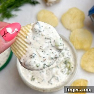 Creamy Dill Pickle Dip Recipe for Parties and Snacks 7 chip dip being held in hand