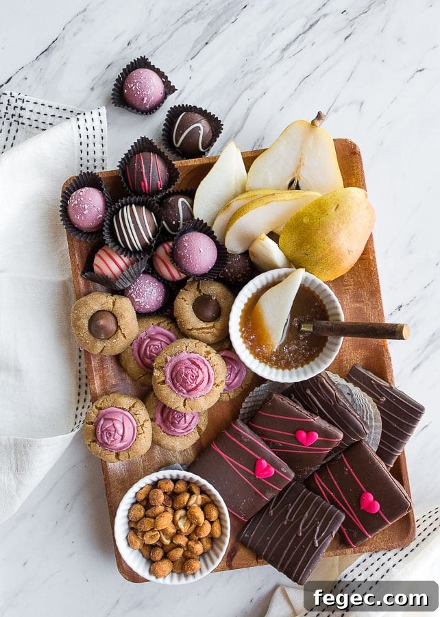 Wooden board with assorted sweets and caramel sauce.
