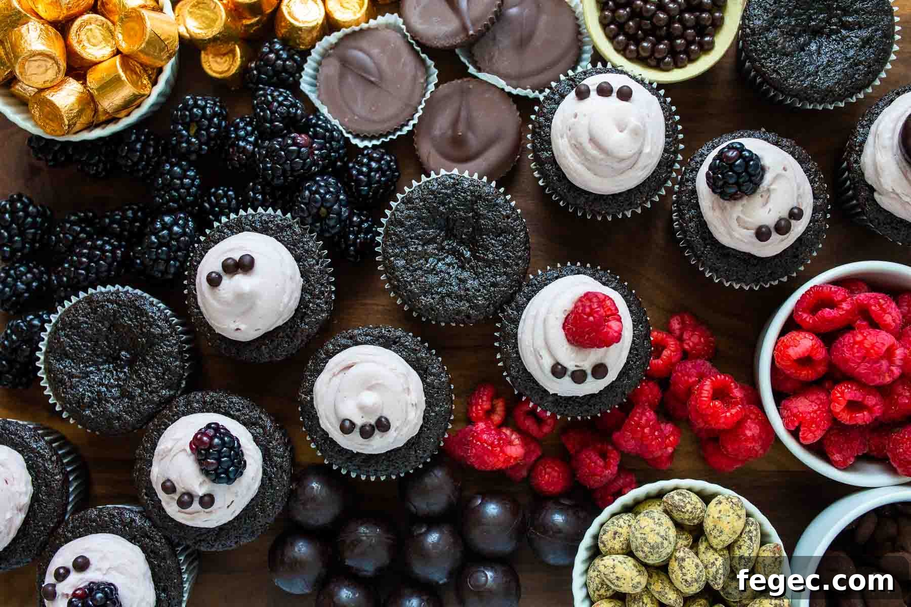 Close up of cupcakes and fruit on board.