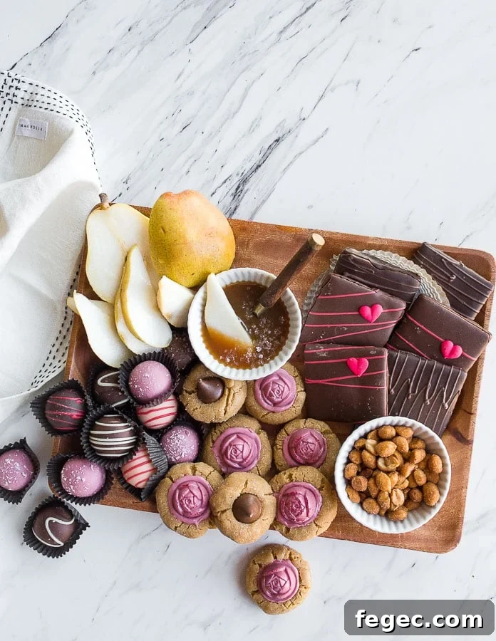 Dessert charcuterie board with fresh fruit, candy and cookies.