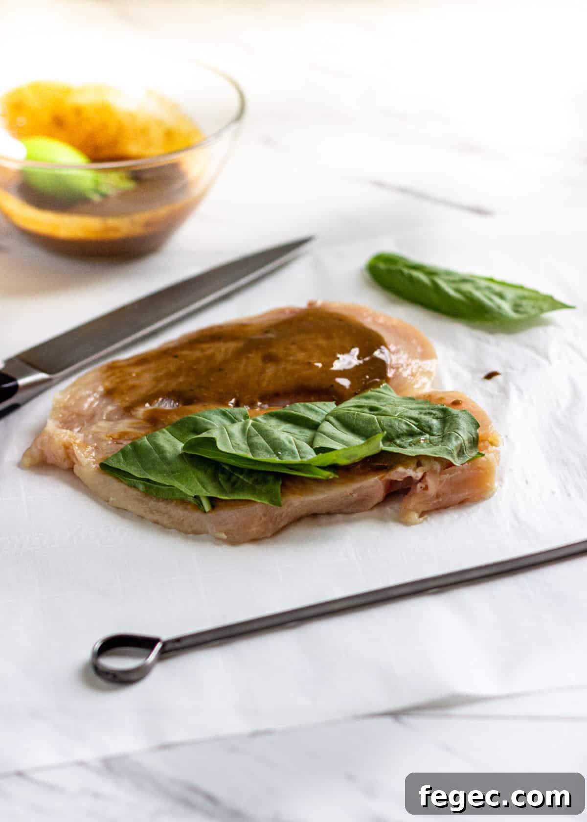 raw chicken split in half and filled with basil