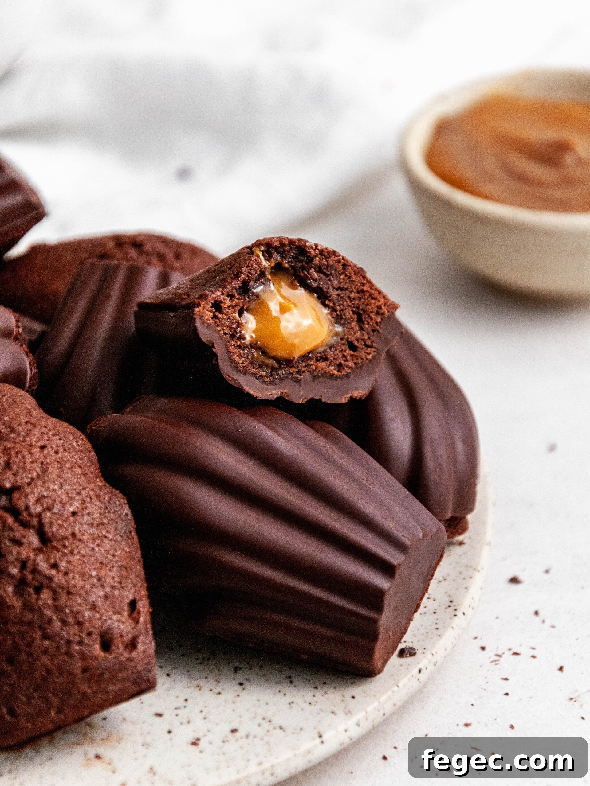Chocolate madeleines with Dulce de Leche cut in half.