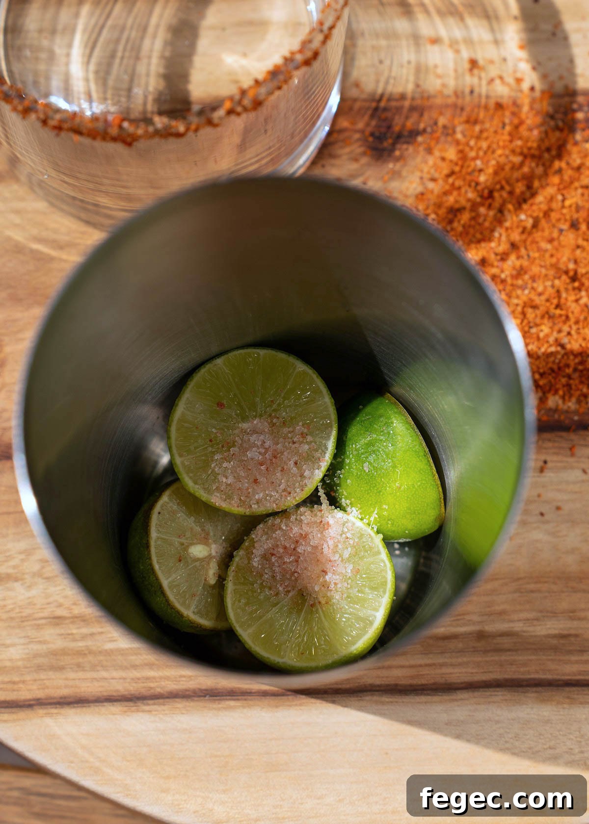 salt added to key limes in a shaker