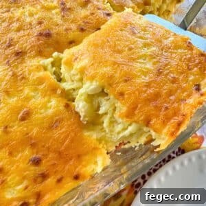 A serving of spaghetti squash au gratin being lifted out of a casserole dish.