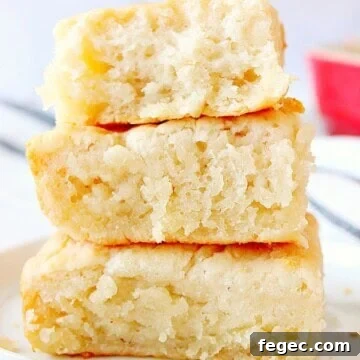 7-UP Biscuits stacked up on white plate.