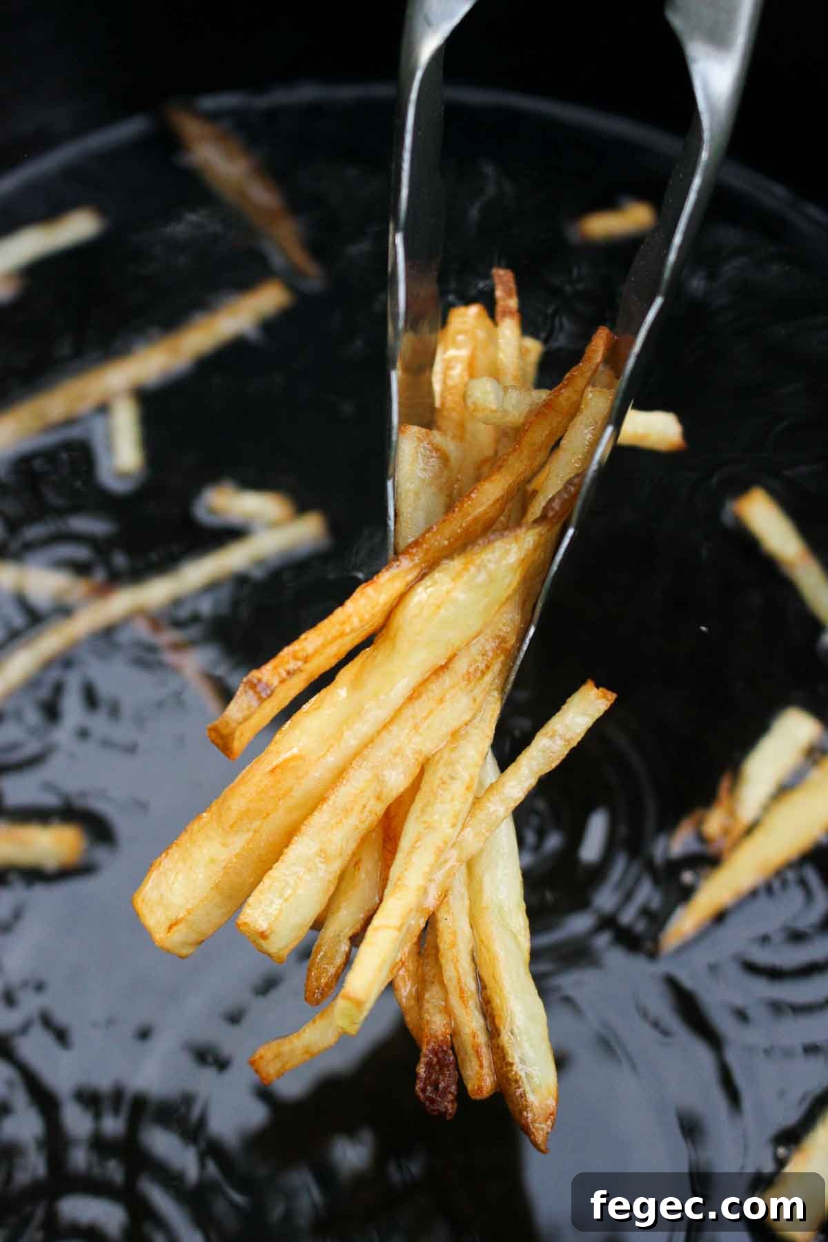 Pulling the fries out of the frying oil for our steak frites recipe!