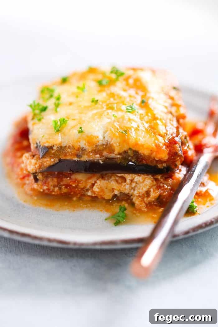 A piece of eggplant lasagna on a white plate.