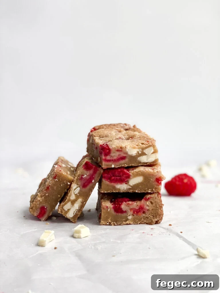 White Chocolate Raspberry Blondies Recipe — Chewy Fruity Bars 2 White chocolate raspberry blondies stacked on top of each other