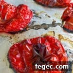 roasted red peppers shown on foil lined cookie sheet