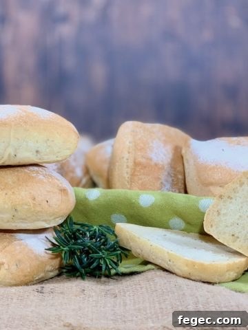 stack of herb sourdough ciabatta rolls with one slice
