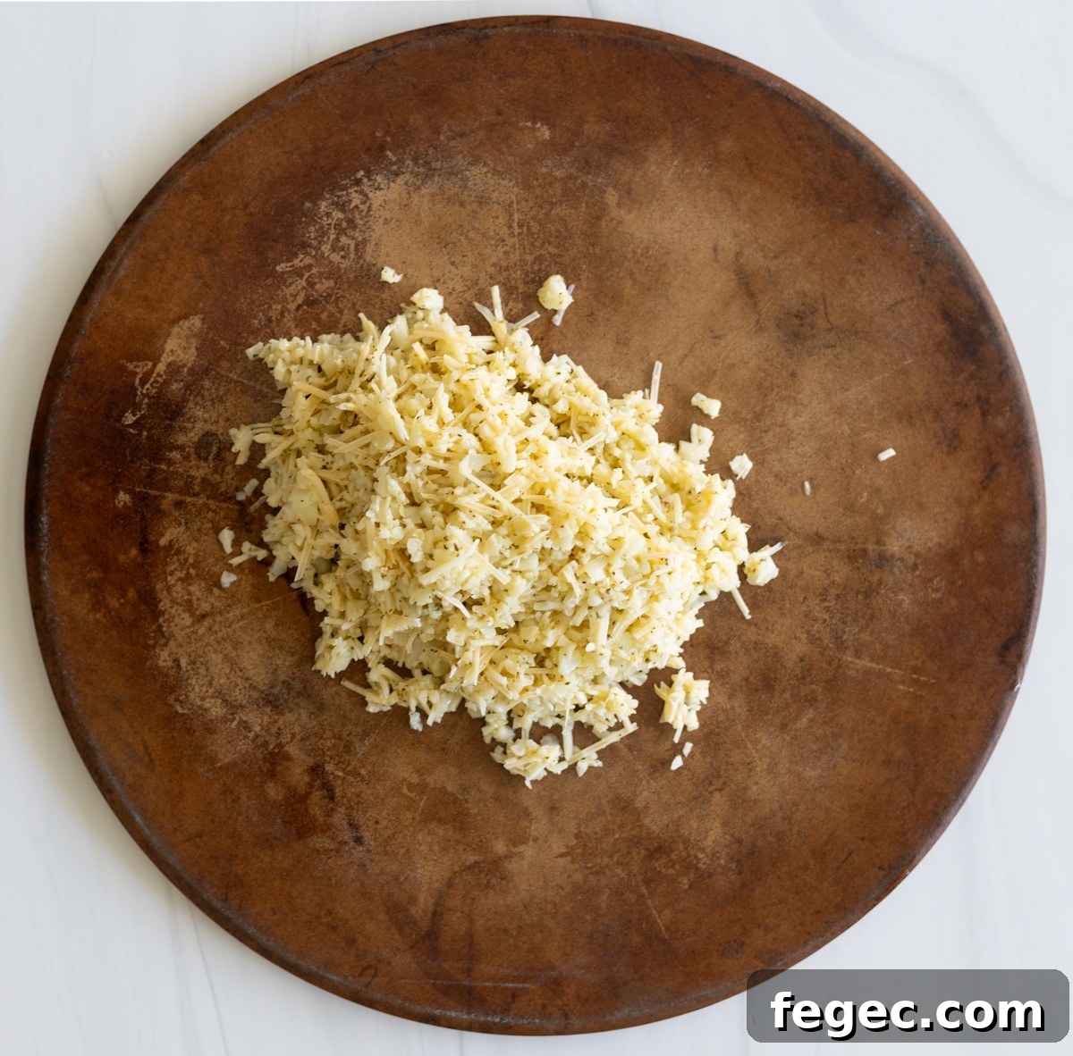 Cheesy Garlic Cauliflower Breadsticks Recipe for Low-Carb Snacking 6 Cauliflower breadstick batter on a baking stone.