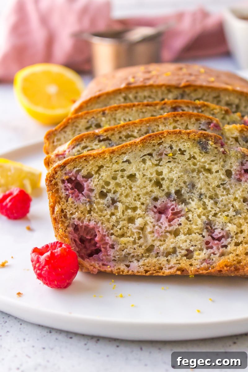 sliced raspberry lemon loaf on a white plate