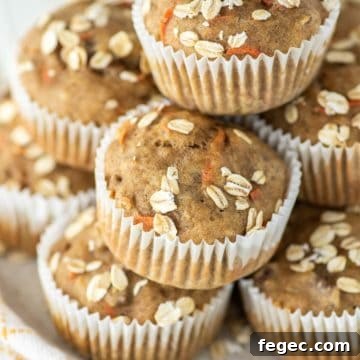 stacked banana carrot muffins with oats on plate