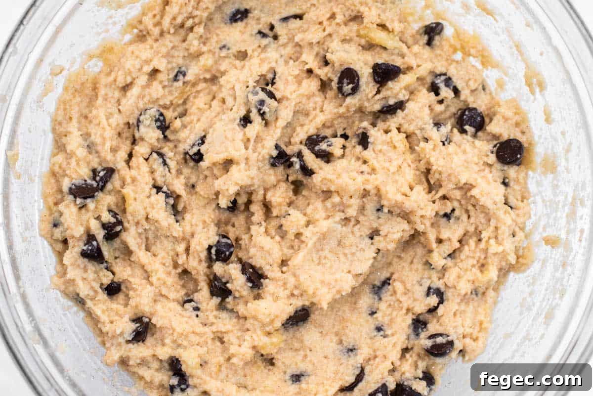 Almond flour banana muffin batter with chocolate chips in bowl.