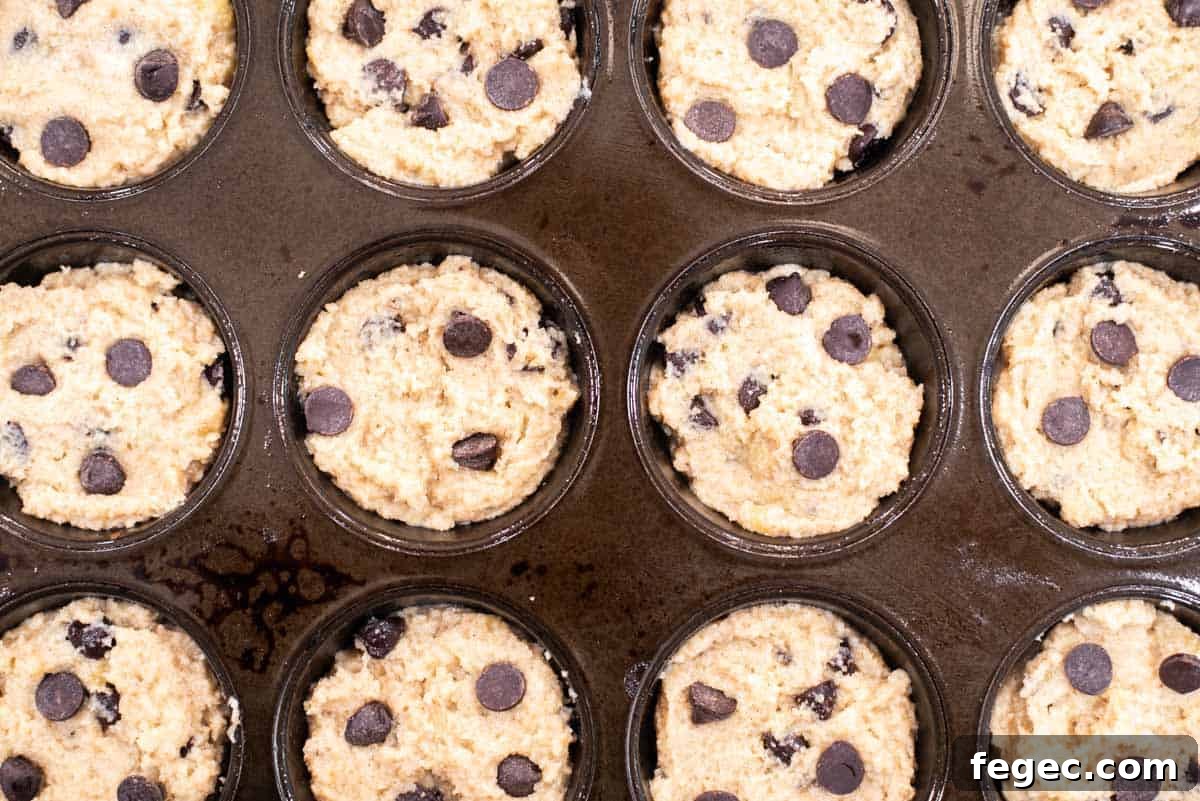 Banana muffin batter in muffin pan.