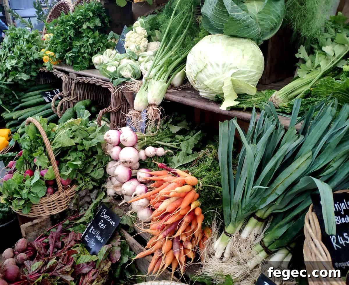 Fresh vegetables bundled on tables at a farmers market.