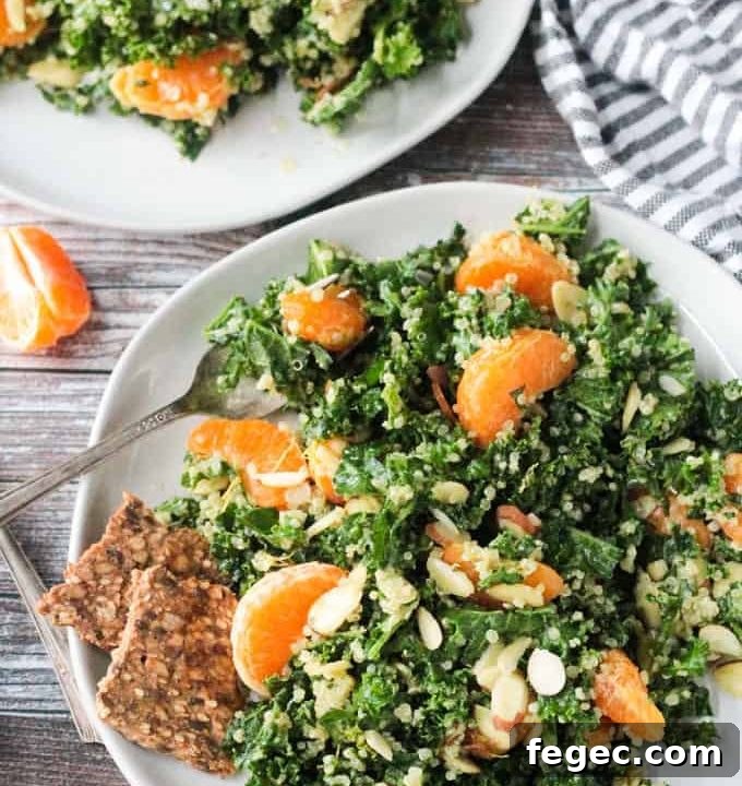 Kale and quinoa salad with orange segments and slivered almonds.