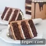 slice of tuxedo cake on a plate with the rest of the cake in the background