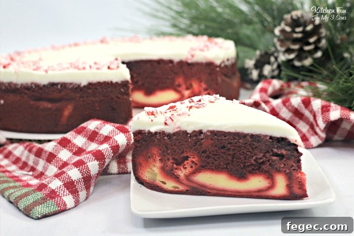 Candy Cane Cheesecake Cake is a fun holiday dessert recipe with a layer of moist Red Velvet cake, a layer of cheesecake and topped with a homemade cream cheese frosting.