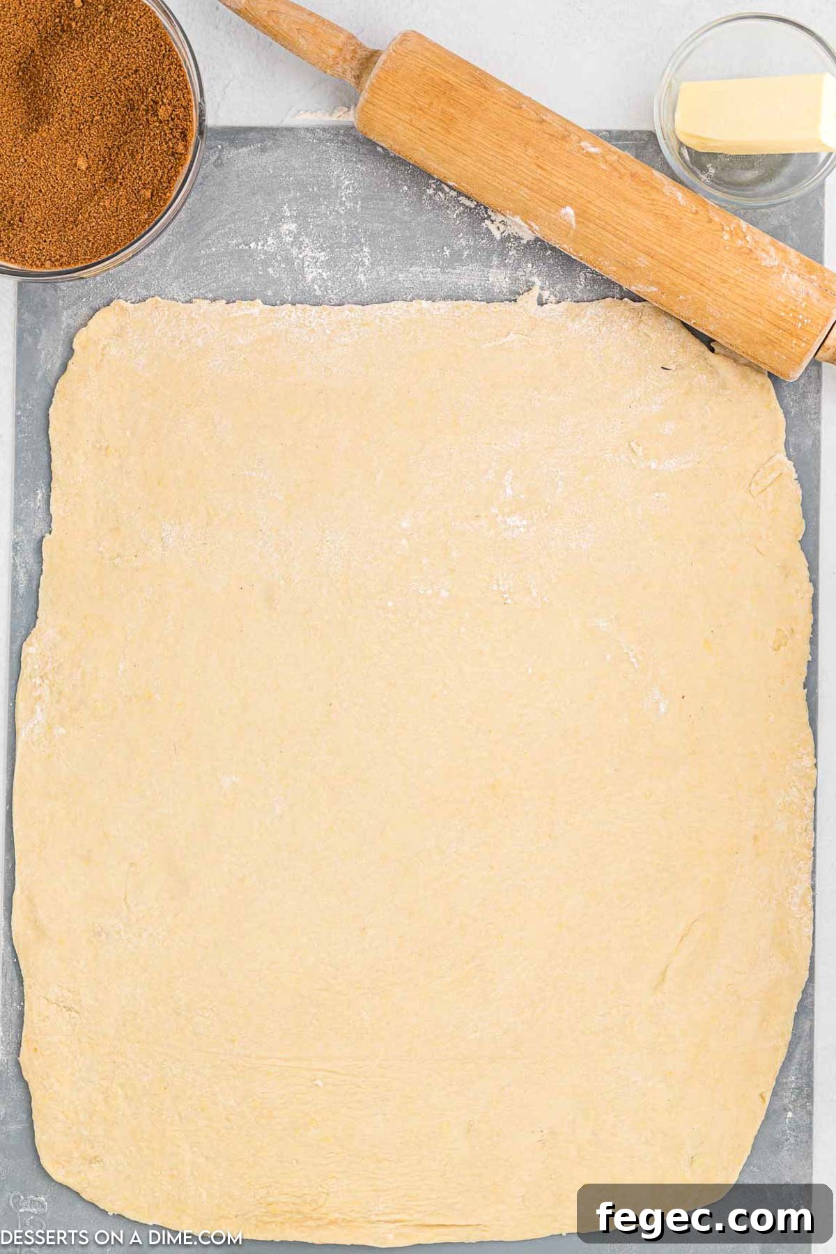 Dough rolled out on a floured surface.