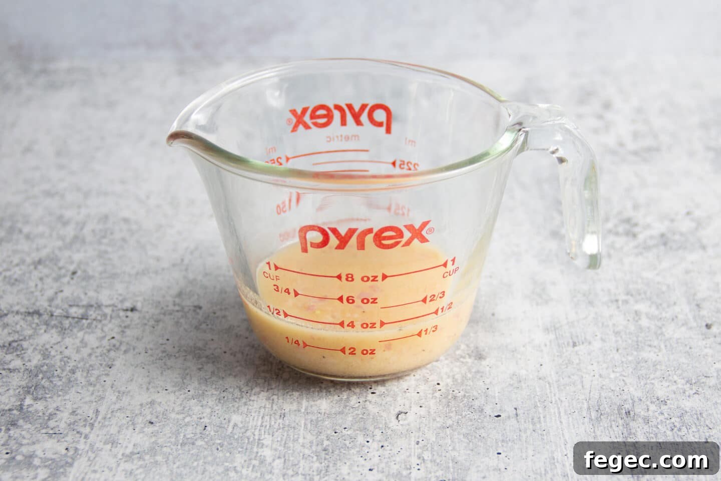 This is a picture of a cup with the salad dressing.
