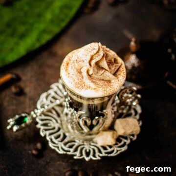 Gorgeous medieval glass filled with coffee and topped with pumpkin flavored whipped cream.