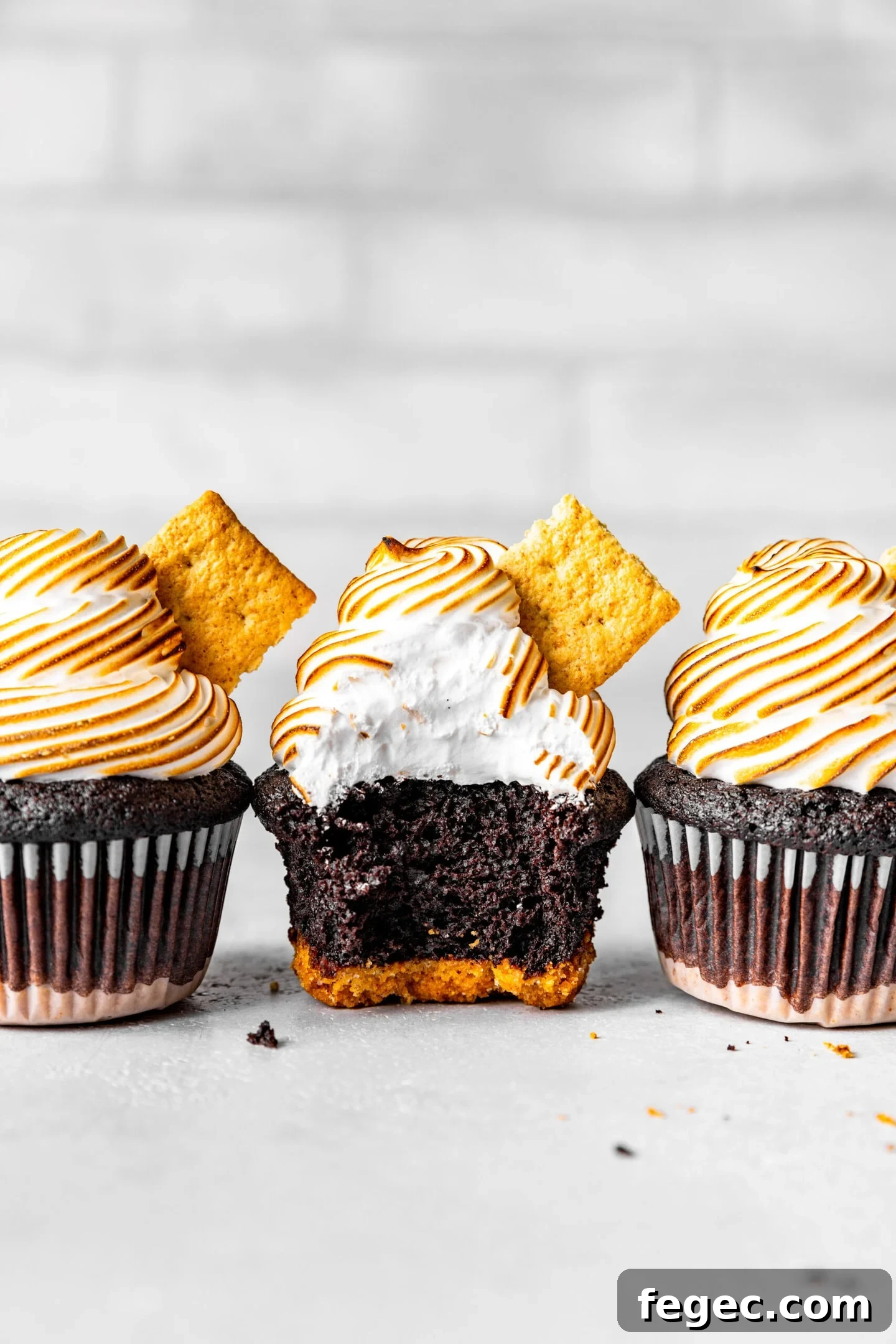 15-Minute Marshmallow Meringue Frosting Recipe 3 Marshmallow meringue frosting on top of s'mores cupcakes