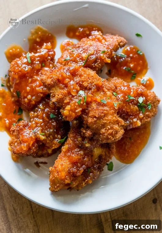 Juicy chicken strips or chicken tenders recipe on a plate 