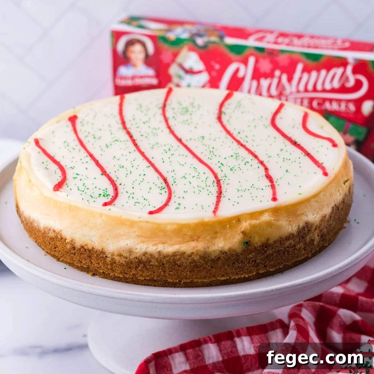 Little Debbie Christmas Tree Cheesecake on a cake platter on table 