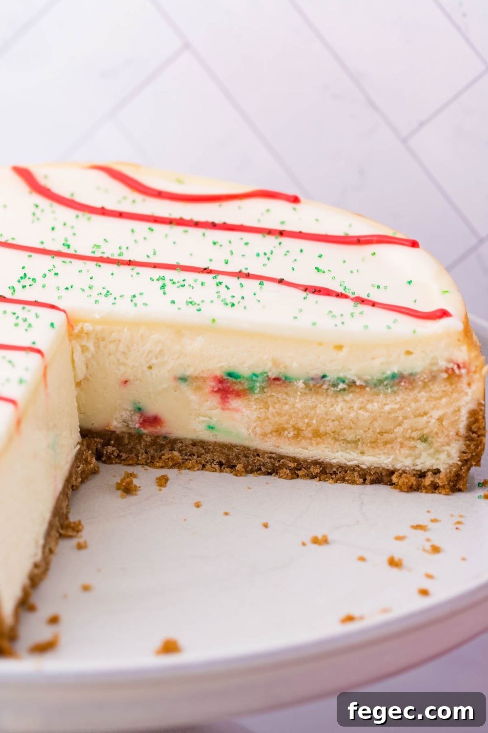 Little Debbie Christmas Tree Cheesecake with a few slices cut out on platter 