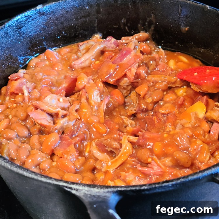 Smoked Pulled Pork Baked Beans in dutch oven before smoking