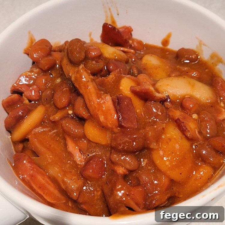 Smoked Pulled Pork Loaded baked beans served in a white bowl