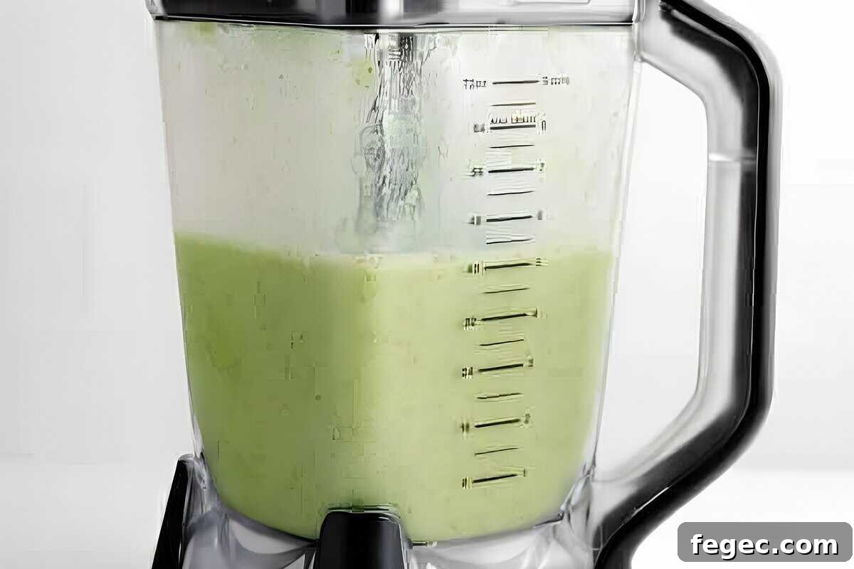 Island Green Tropical Smoothie Recipe for Refreshing Energy 9 Green smoothie in a blender.