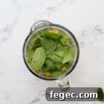 Island Green Tropical Smoothie Recipe for Refreshing Energy 5 overhead view of ingredients for an island green tropical smoothie in a blender before blending.