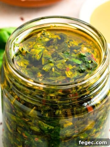 Up close view of a jar of basil chimichurri sauce