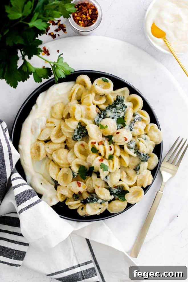 a plate with whipped ricotta and pasta with kale