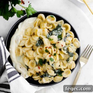 a plate with whipped ricotta and pasta with kale
