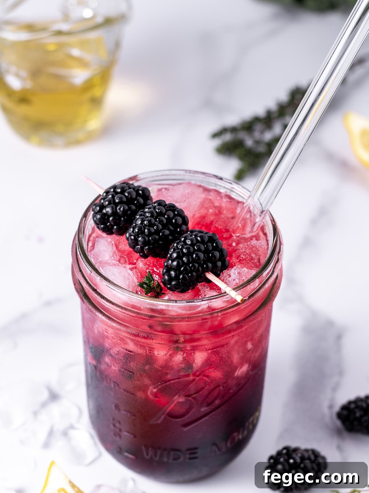 Refreshing Blackberry Smash Mocktail Recipe 3 glass jar and glass straw with blackberry thyme mocktail