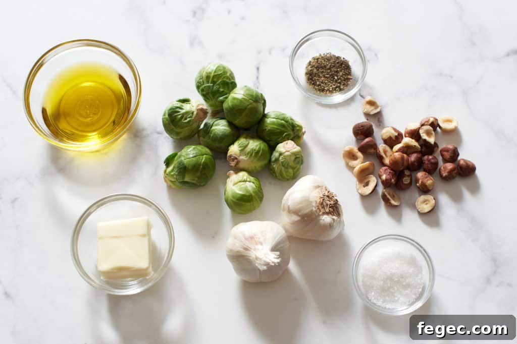 Brussels sprouts, hazelnuts, garlic bulbs, and small bowls with butter, olive oil, and salt and pepper.