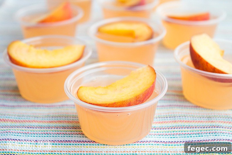 Peach Fizz Jello Shots are about to become your go-to summer cocktail! Super easy to make and crazy good, these shots disappear in a flash!