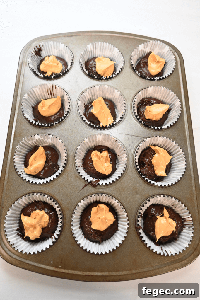 The cupcake liners full of chocolate cake batter and and dulce de leche cheesecake