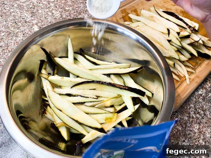 Pouring salt into water bowl filled with eggplant slices
