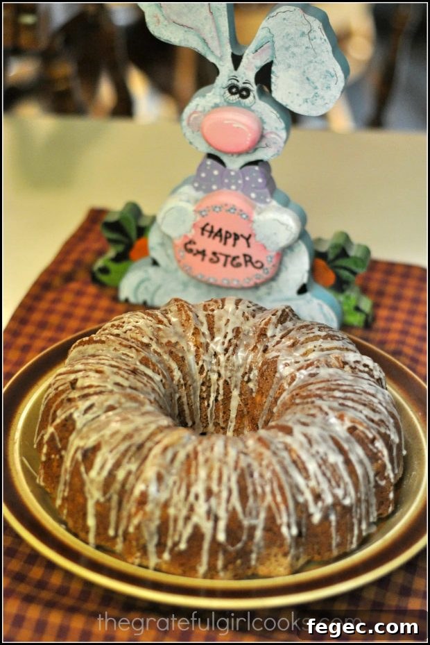 Hummingbird Cake on platter, with Easter bunny behind it.