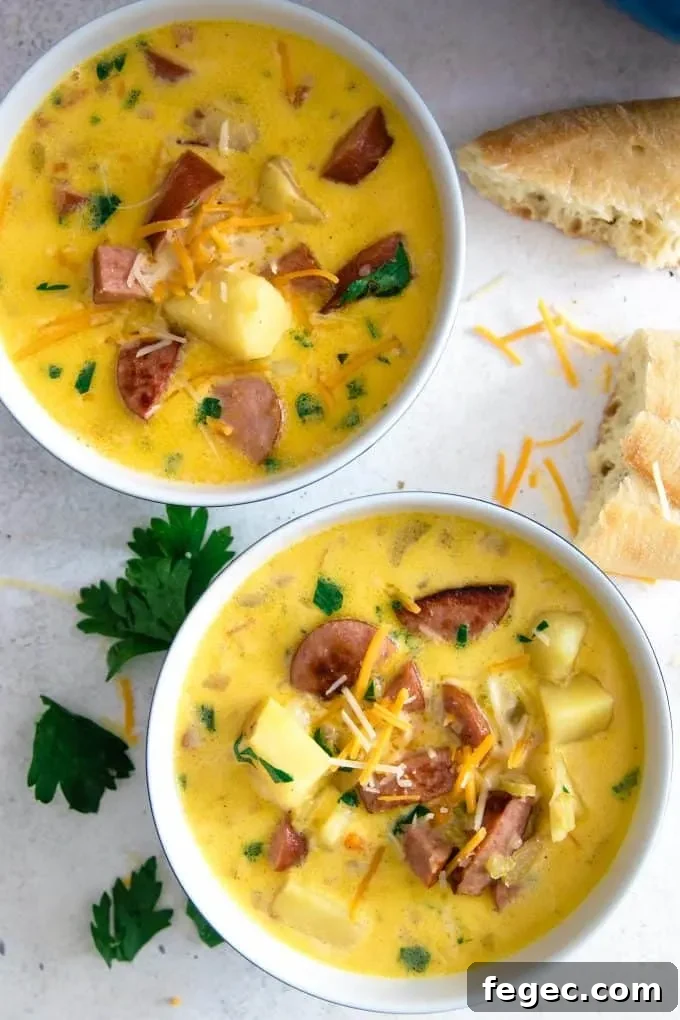 2 bowls of potato kielbasa soup with chunks of crusty bread