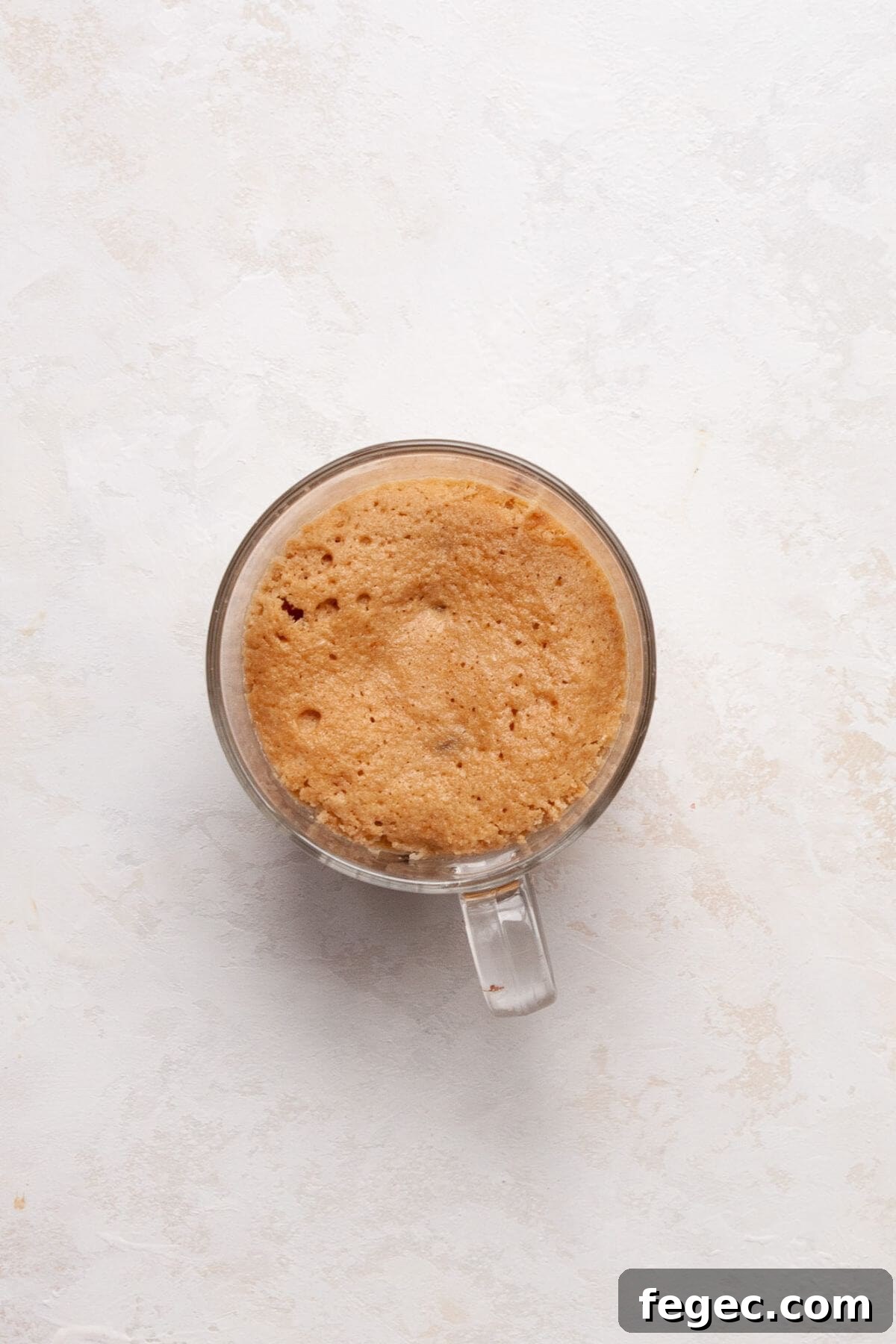 Protein Powder Mug Cake Recipe: Quick High-Protein Dessert in Minutes 6 Fluffy protein mug cake after cooking in the microwave for 60 seconds.