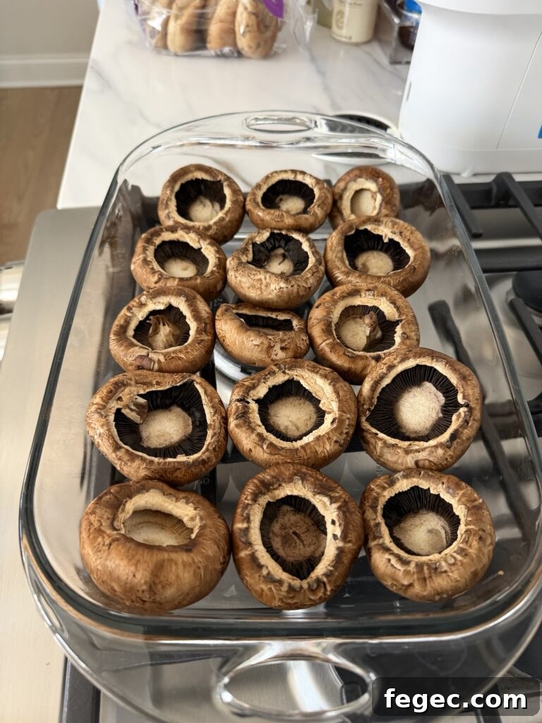 Steakhouse Garlic Butter Marinated Grilled Mushrooms 3 Mushroom caps upside down in a baking dish