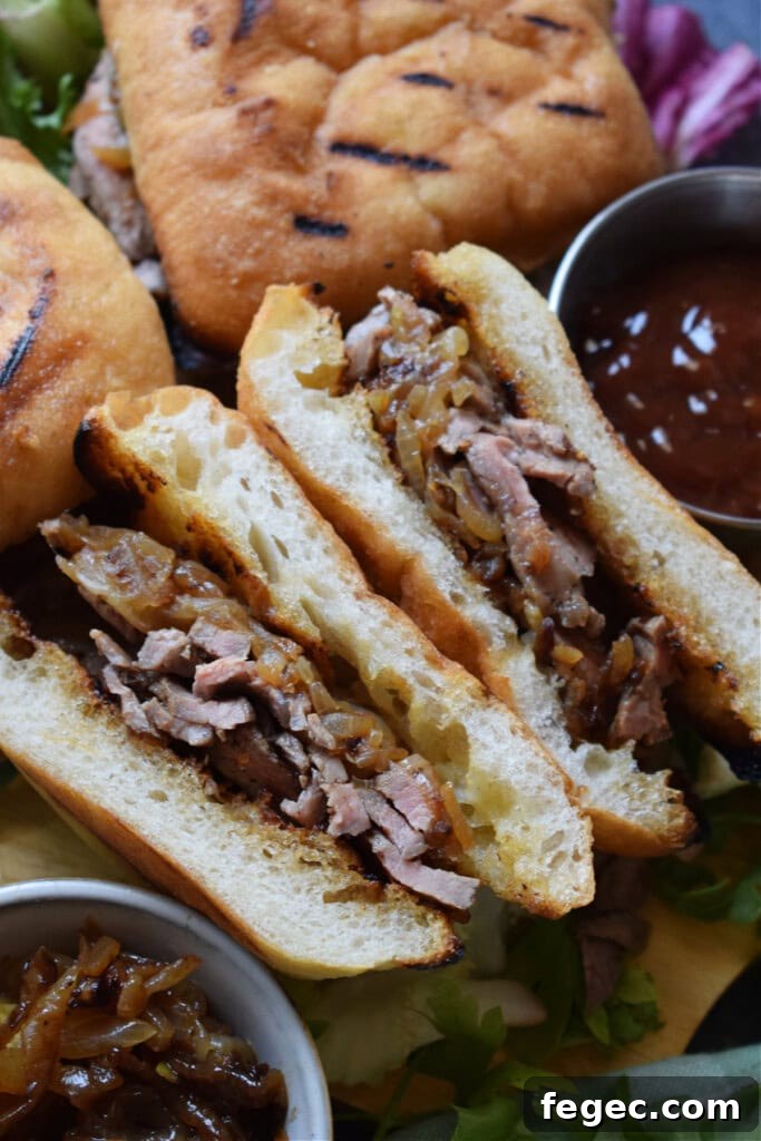 Close up of steak sandwiches with cheese.