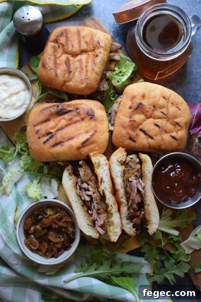Steak sandwiches with cheese and onions.